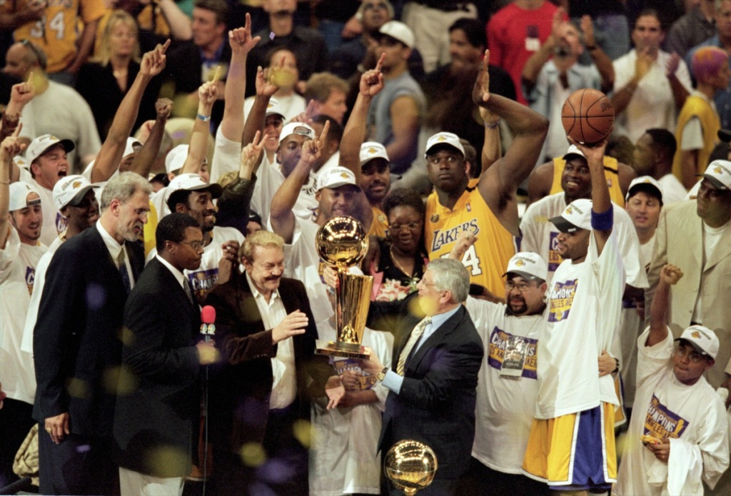 Commissioner David Stern presents owner of the Los Angeles Lakers Jerry Buss the NBA Championship trophy in action during the NBA Finals Game 6 against the Indiana Pacers at the STAPLES Center in Los Angeles, CA.