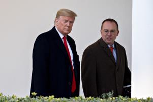 Donald Trump, Mick Mulvaney are posing for a picture: U.S. President Donald Trump, left, and Mick Mulvaney, acting White House chief of staff, walk through the Colonnade of the White House before boarding Marine One in Washington, D.C., U.S., on Monday, Jan. 13, 2020.