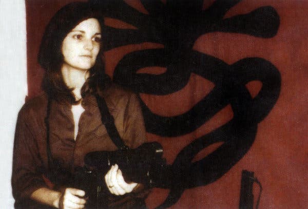 Patricia Hearst in front of a Symbionese Liberation Army flag in April 1974.