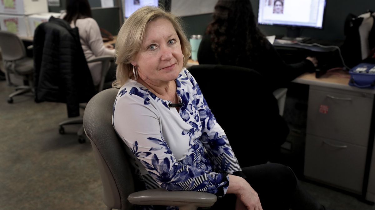 In this Thursday, Jan. 16, 2020 photo Jo Goode, city hall reporter for The Herald News of Fall River, Mass., sits for a photo in the paper's newsroom, in Fall River. Goode's paper has already laid off most of its reporting staff and recently announced plans to sell its historic downtown office to trim costs. (AP Photo/Steven Senne)