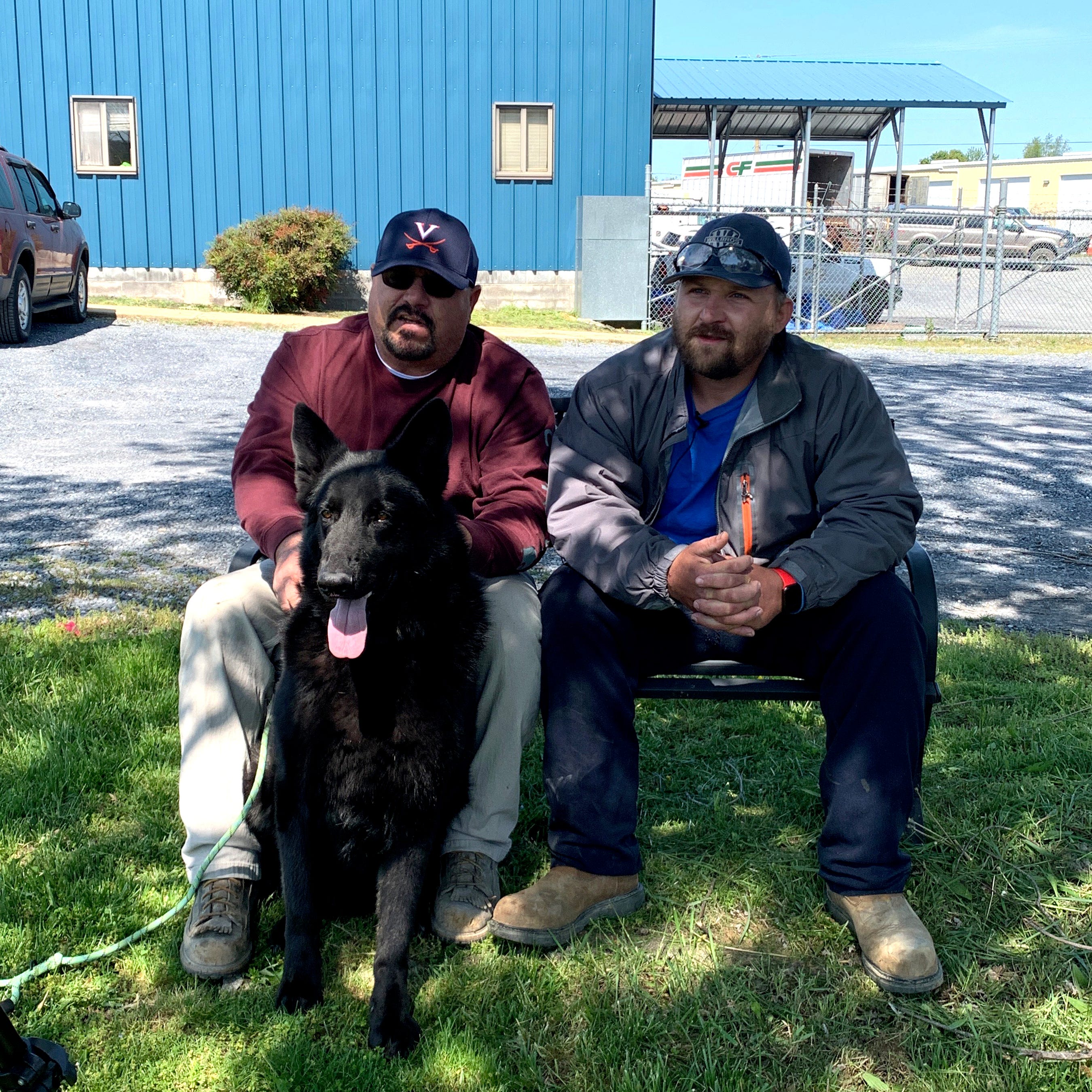Jay Johnson and Cavaja Holt with Jett Thursday morning, May 7. The two men helped save Jett's life when the dog was choking on a ball Wednesday. Johnson coached, and Holt pulled the ball out of Jett's mouth and gave him mouth-to-mouth resuscitation.