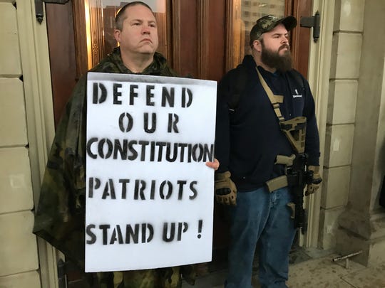 People protest Gov. Gretchen Whitmer's stay-at-home order at the Capitol in Lansing on Thursday, May 14, 2020.