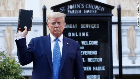 President Donald Trump holds a Bible as he visits outside St. John&#39;s Church across Lafayette Park from the White House Monday, June 1, 2020.