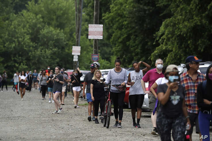 People wait in line to vote in the Georgia's primary election at Park Tavern on Tuesday, June 9, 2020, in Atlanta. (AP Photo…