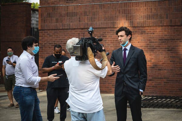 Jon Ossoff talked to a local news affiliate while waiting to vote in Atlanta on Friday, the final day of early voting. 