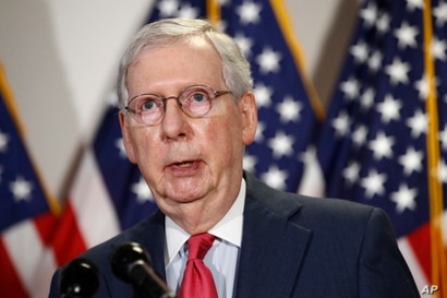 In this May 19, 2020, photo, Senate Majority Leader Mitch McConnell of Ky., speaks with reporters after meeting with Senate…