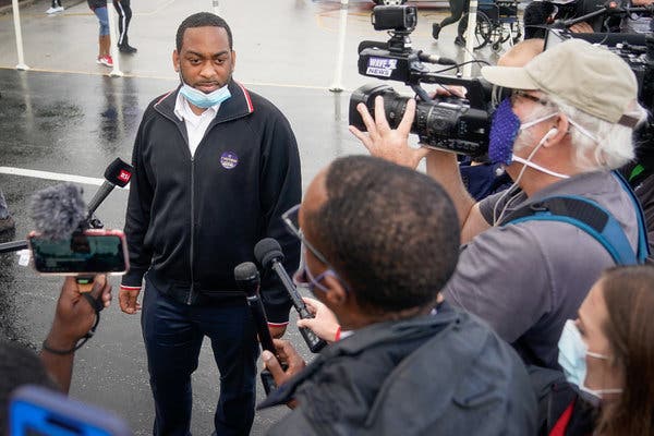 Representative Charles Booker speaks with the press outside the only primary election polling place in Louisville.