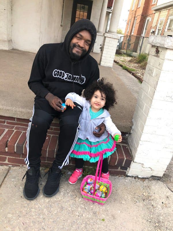 Basil Miles, 27, with his 3-year-old daughter. He was laid off from his food service job because of the coronavirus.