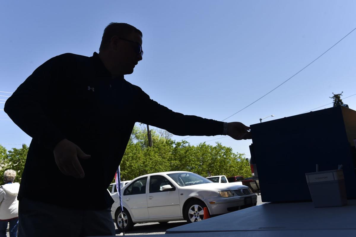 Voters drop off their ballots Tuesday outside the City-County Building in Helena.