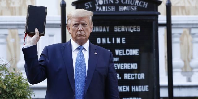 President Donald Trump holds a Bible as he visits outside St. John's Church across Lafayette Park from the White House Monday, June 1, 2020, in Washington. Park of the church was set on fire during protests on Sunday night. (AP Photo/Patrick Semansky)