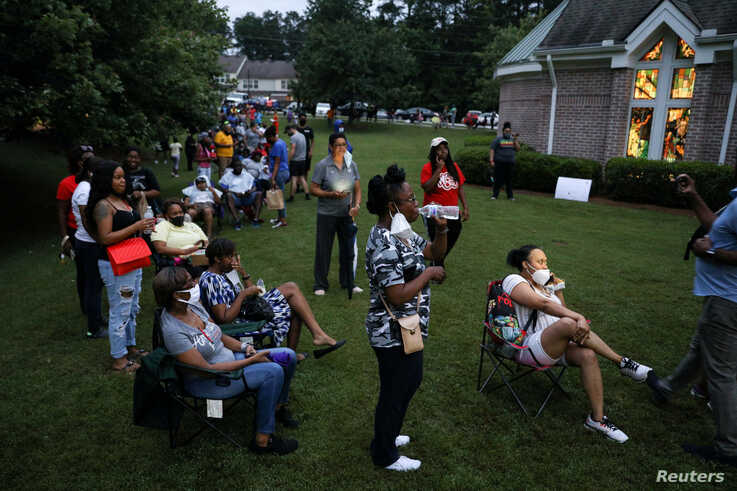 Voters line up at Christian City, an assisted living home, to cast their ballots in Democratic and Republican primaries 