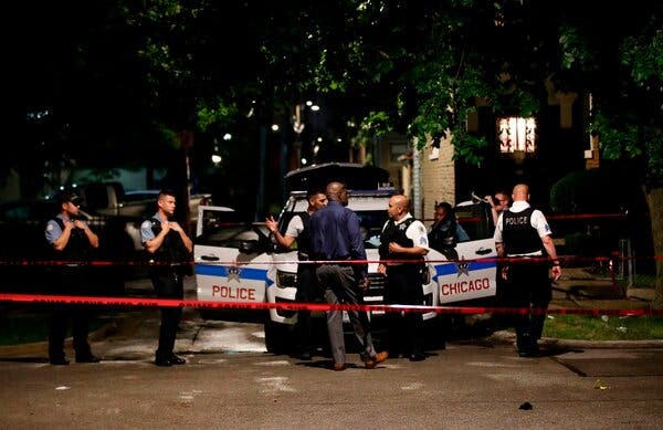 Police officers on Tuesday at the scene of a shooting in Chicago.
