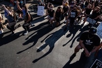 Image: Thousands of peaceful protesters raise their fists and kneel near George Floyd’s memorial site in Minneapolis on June 5.