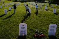 Image: Children run around an installation in Minneapolis of memorial tombstones of victims of police killings on June 5.