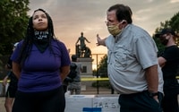 Image: Anais, 26, who wants to remove the Emancipation statue in Lincoln Park in Washington, argues with a man who wants to keep it on June 25.