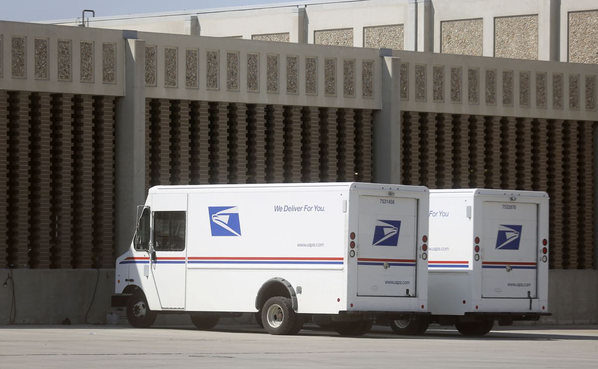 U.S. Postal Service vehicles are parked outside of a post office in Salt Lake City on Tuesday, Aug. 18, 2020.