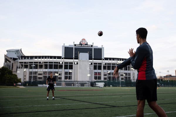Students played football outside of Ohio State University’s stadium on Tuesday.