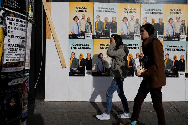  Signs advertising the 2020 census cover a boarded up business during the coronavirus outbreak in March in Seattle.