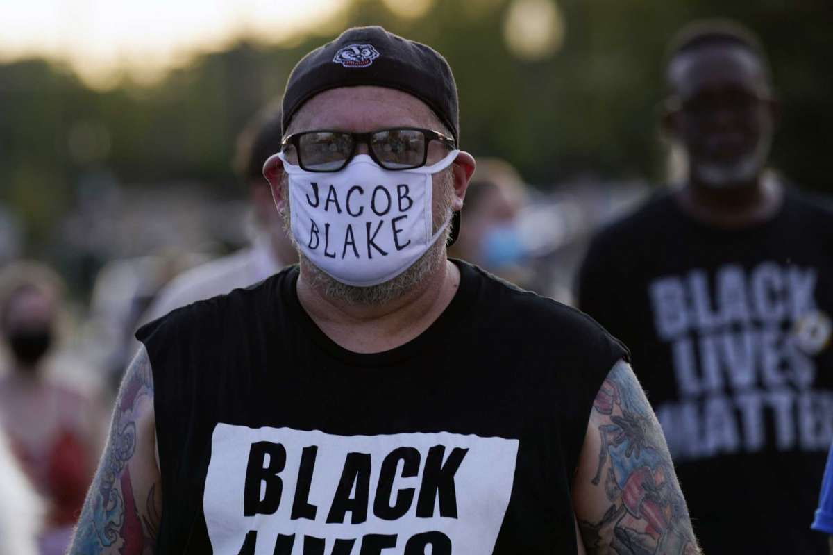 Protesters march against the Sunday police shooting of Jacob Blake Thursday, Aug. 27, 2020, in Kenosha, Wis. (AP Photo/Morry Gash)