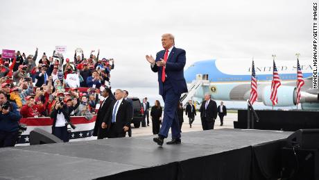 US President Donald Trump claps as he arrives arrives for a campaign rally at MBS International Airport in Freeland, Michigan on September 10, 2020. 