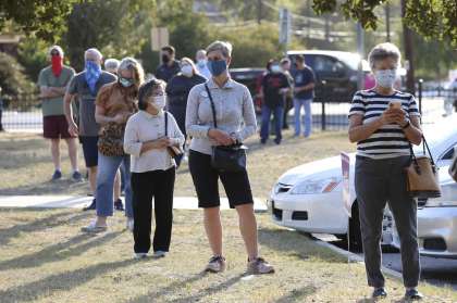 Bexar County residents wait to cast their votes Tuesday at the Lion’s Field polling site.