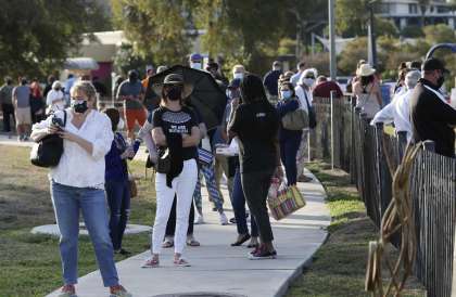 Voters line up outside the Lion’s Field polling site Tuesday. The county has opened 48 polling sites, including new mega locations for this year’s early voting