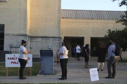 People line up to vote at the Our Lady of the Lake University polling site Tuesday. Theresa Lankford, one of the first people to cast a ballot at the new polling location, said she and her husband, Roland, chose it because they expected few people to be there.