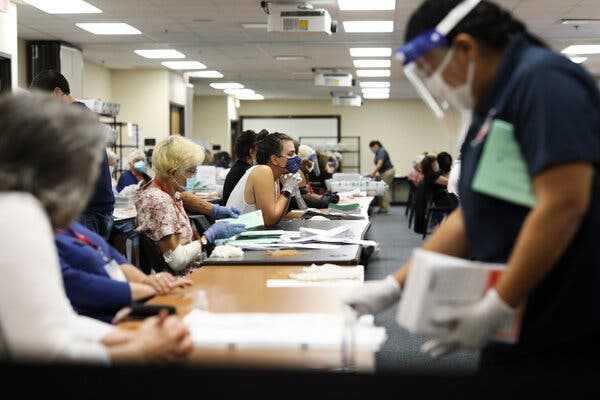 Election workers in Largo, Fla., opening mail-in ballots this month.