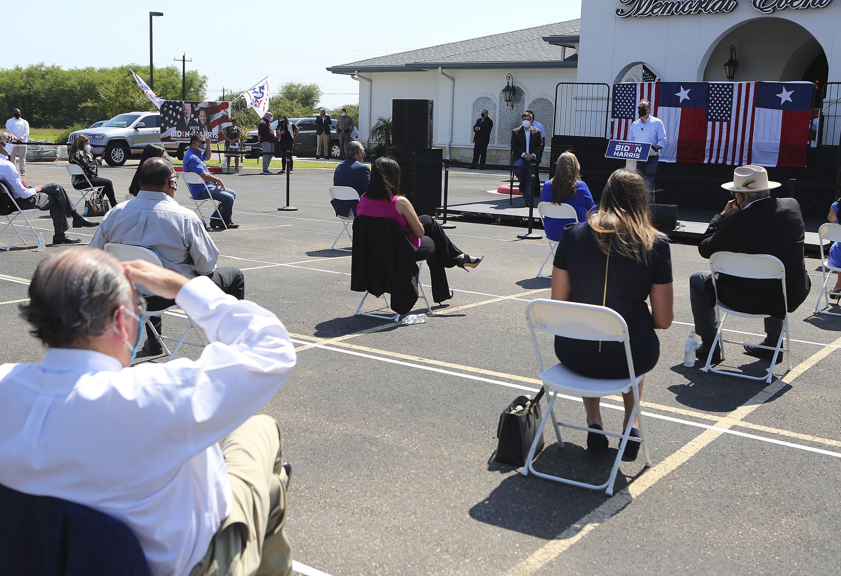 Supporters sit apart as they listen to Sen. Kamala Harris' husband, Doug Emhoff, speak at a Hidalgo County Democratic Party voter registration drive on Monday, Oct. 5, 2020, in Edinburg, Texas. (Joel Martinez/The Monitor via AP)