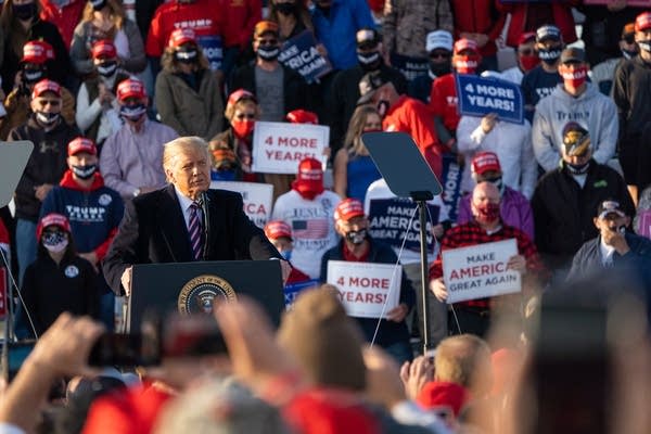 A man speaks at a podium.