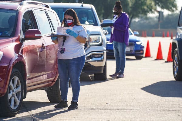 Election workers accepted mail-in ballots from voters at a mail ballot drop-off site in Houston on Wednesday. Gov. Greg Abbott issued an executive order limiting each Texas county to one mail ballot drop-off site.