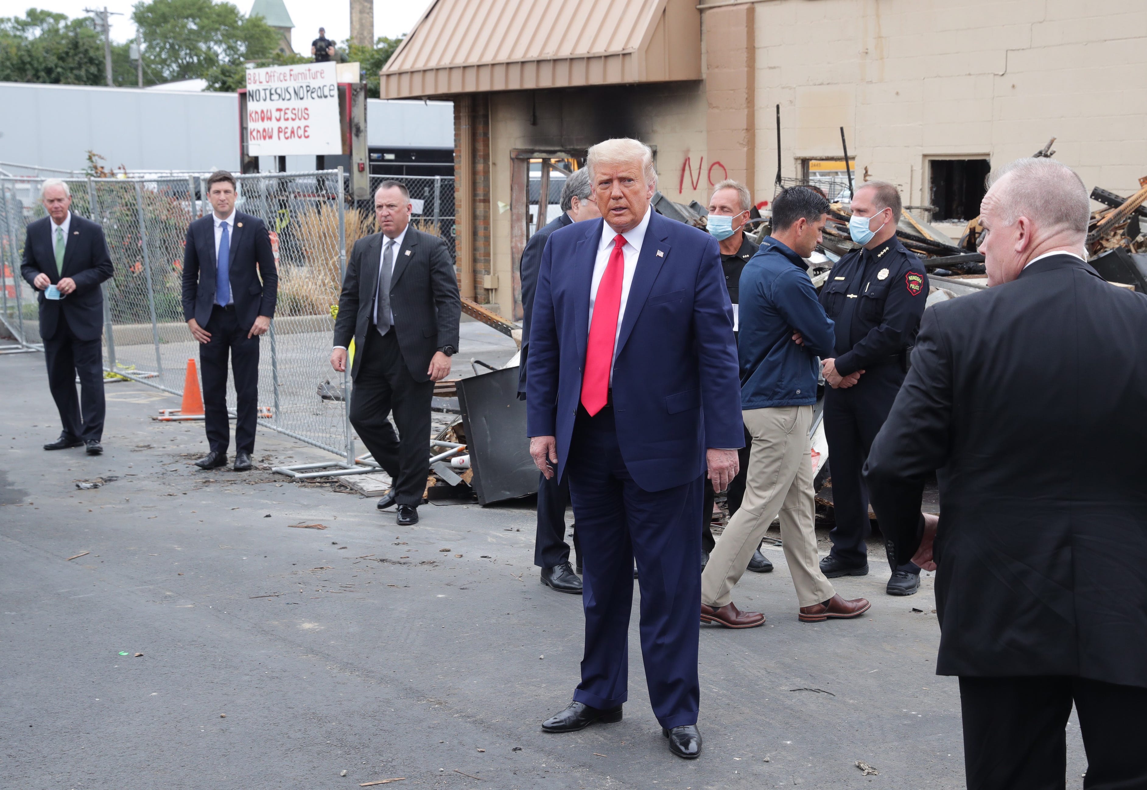 President Donald Trump inspects the remains of B&L Office Furniture on Tuesday, Sept. 1, 2020, in Kenosha, Wis.