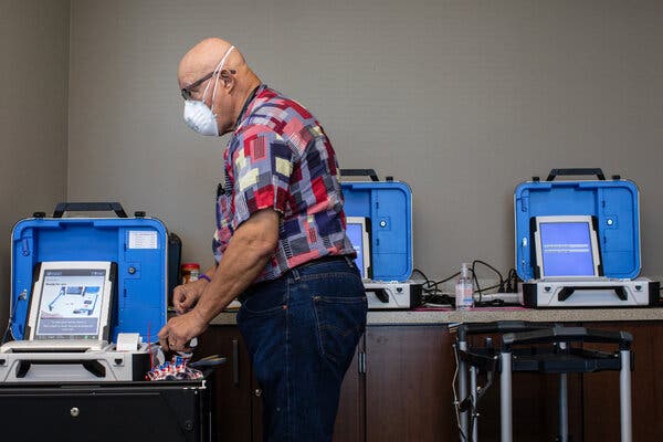 Nicholas Hoover, an election clerk, made final preparations before early voting began on Tuesday at the Hays County Government Center polling place in San Marcos, Texas.